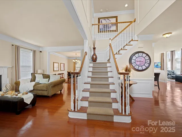 a living room with furniture and a clock