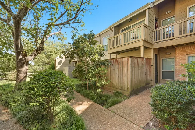 a view of a house with a tree