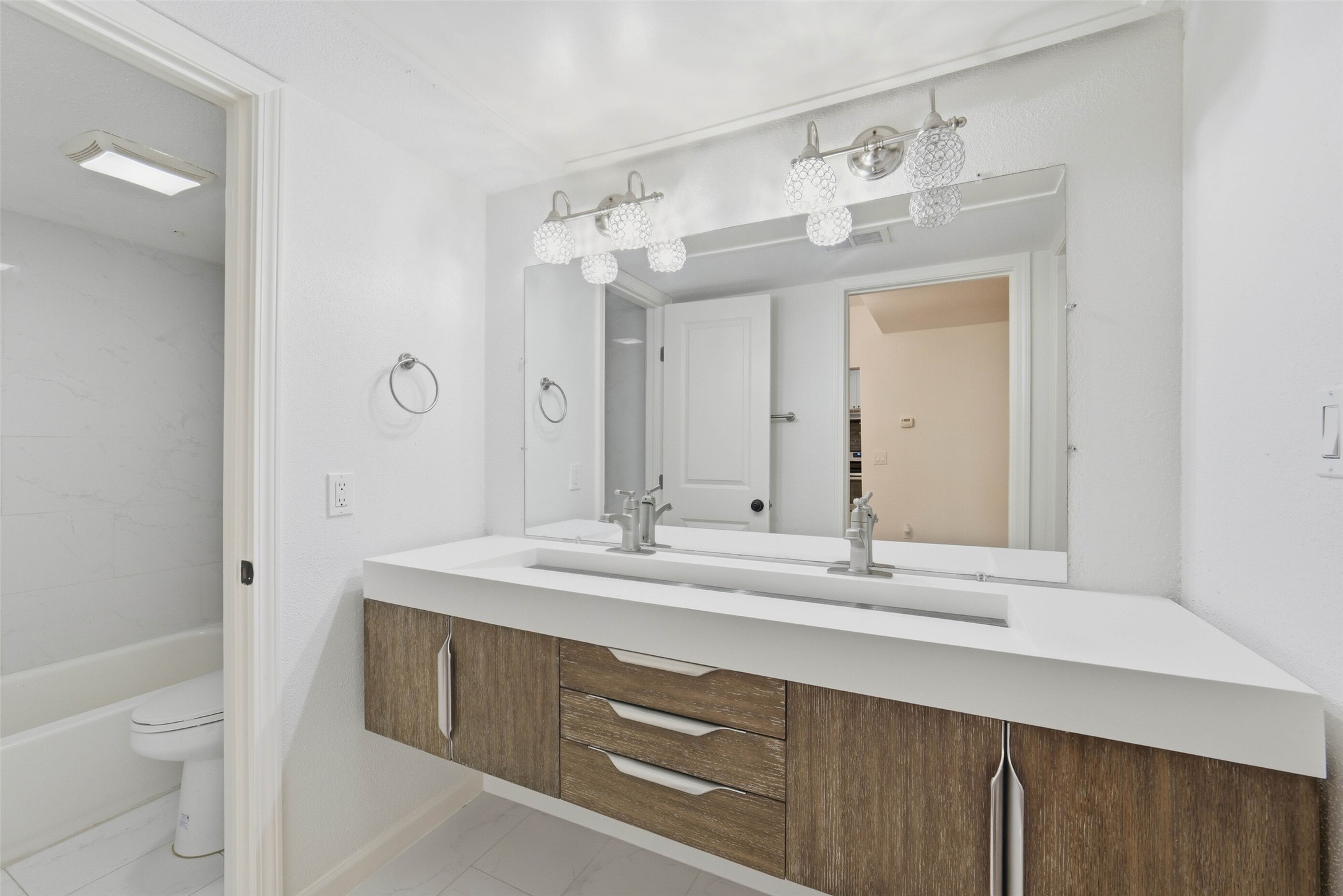 2100 Tanglewilde Street, Unit 625 Houston, TX 77063 - Photo 12 of 23 a bathroom with a sink a toilet and a mirror