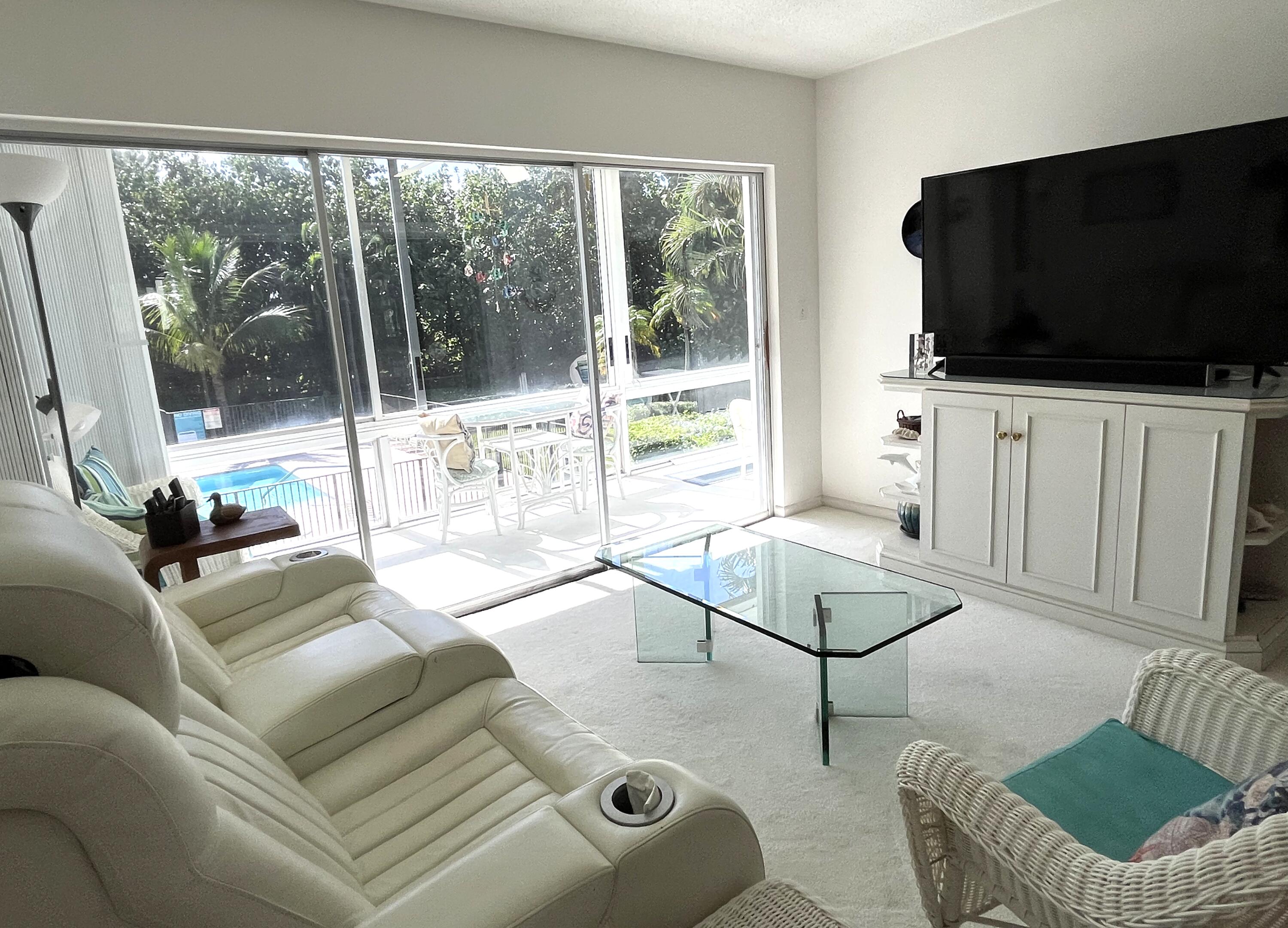 50 Celestial Way, Unit 207 Juno Beach, FL 33408 - Photo 11 of 30 a living room with furniture and a flat screen tv