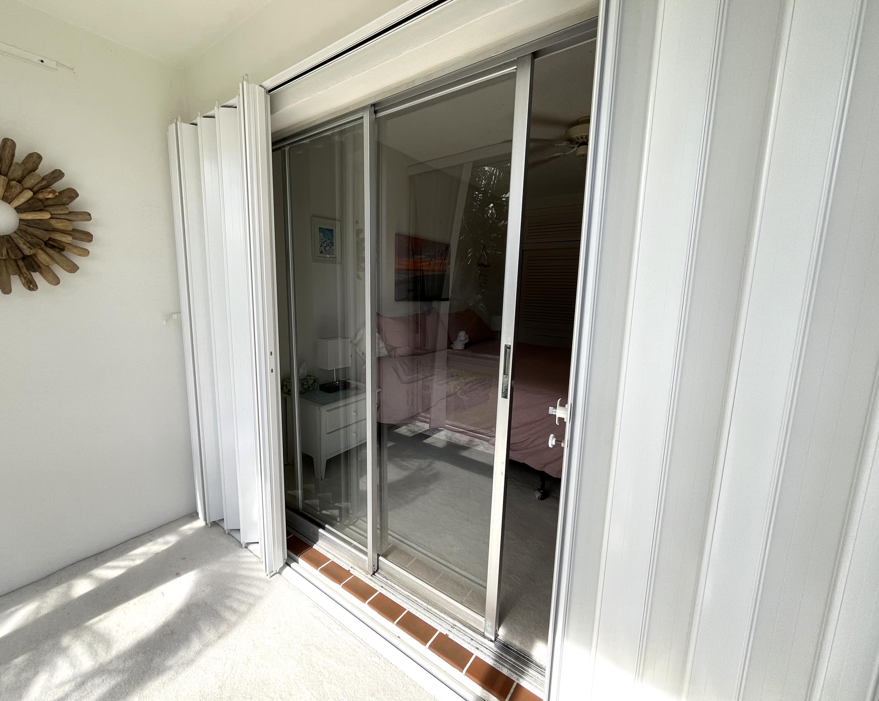 50 Celestial Way, Unit 207 Juno Beach, FL 33408 - Photo 16 of 30 a view of a bathroom with a glass door