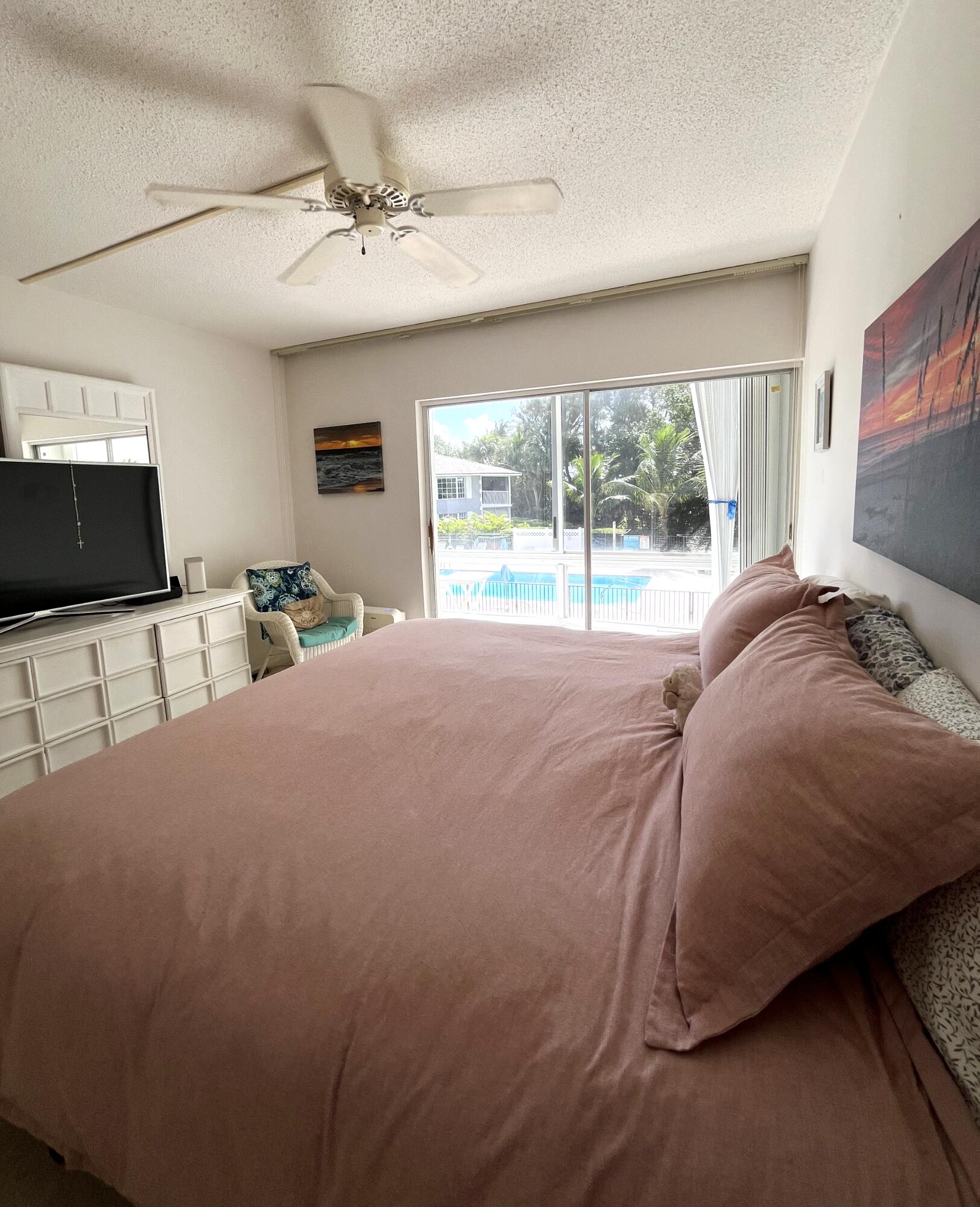 50 Celestial Way, Unit 207 Juno Beach, FL 33408 - Photo 19 of 30 a bed sitting in a bedroom next to a window