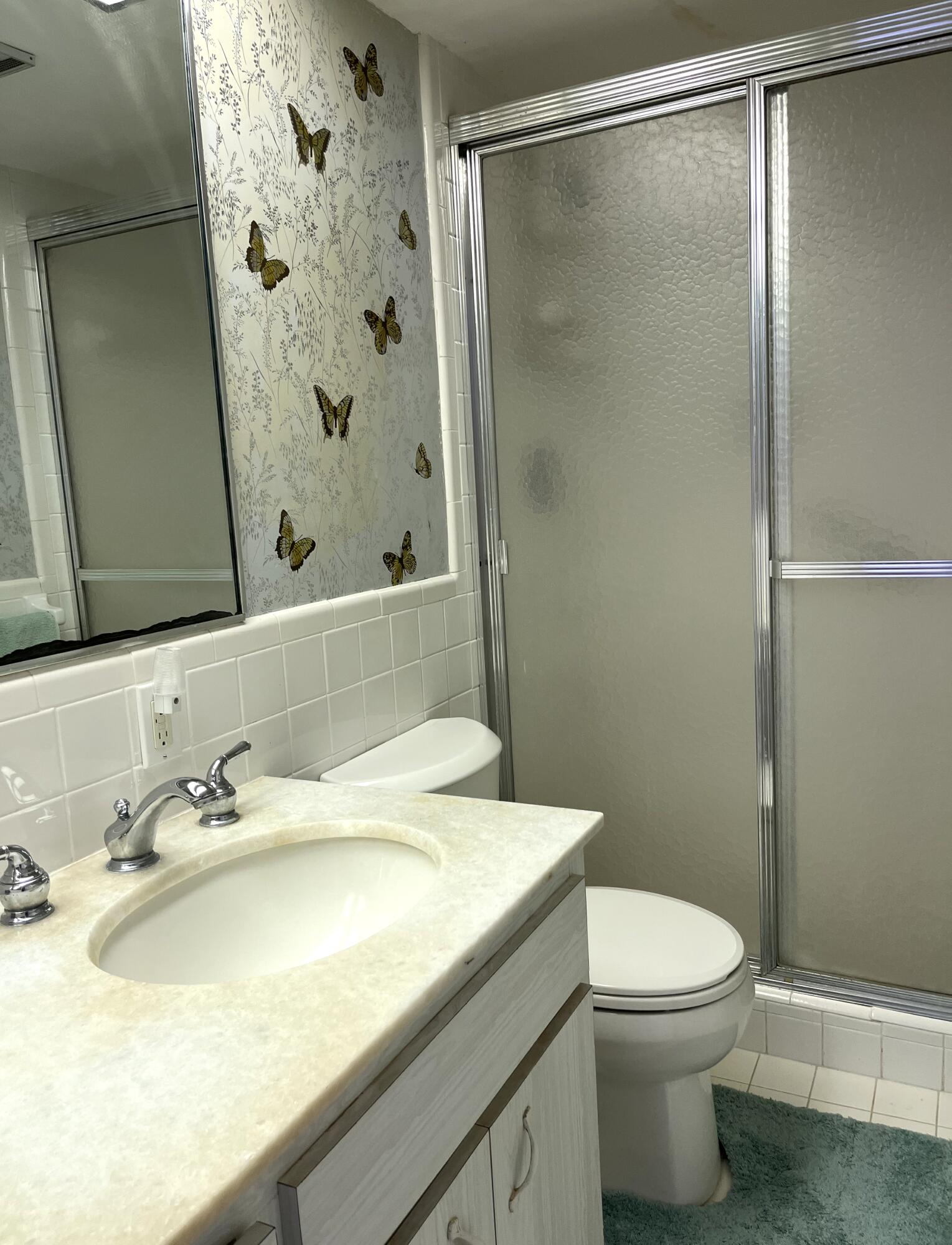 50 Celestial Way, Unit 207 Juno Beach, FL 33408 - Photo 24 of 30 a bathroom with a sink and a mirror