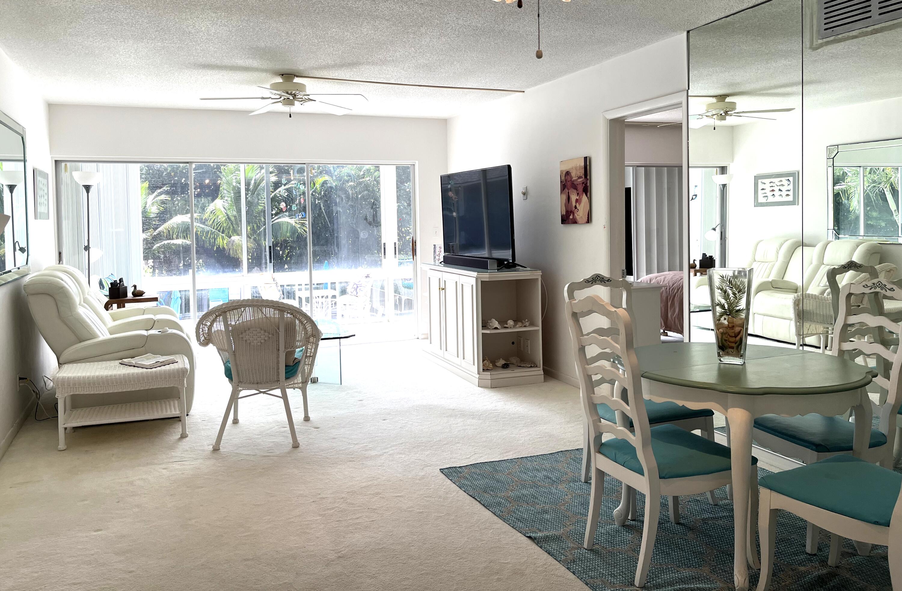 50 Celestial Way, Unit 207 Juno Beach, FL 33408 - Photo 8 of 30 a view of a dining room with furniture window and outside view