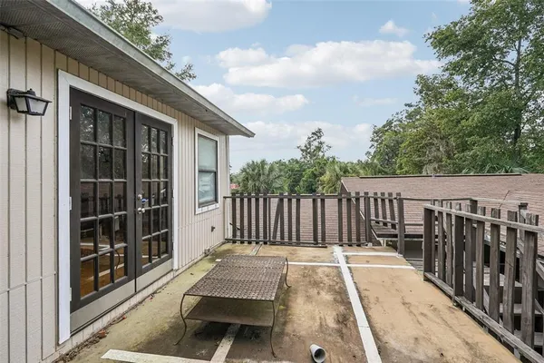a view of balcony with wooden floor and fence