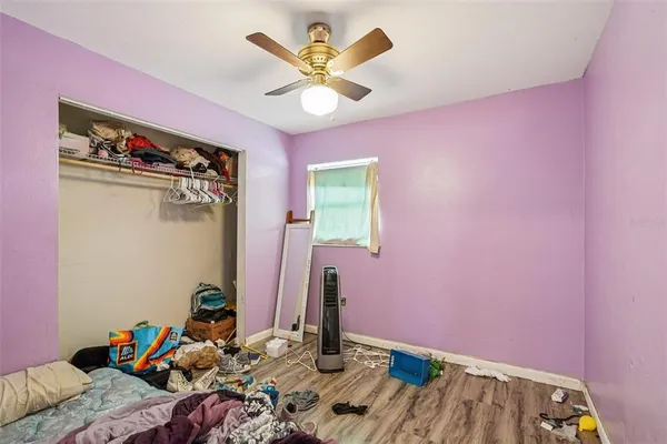 a bedroom with bed and a chandelier