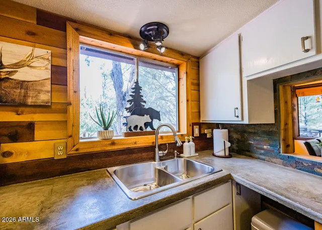 a kitchen with stainless steel appliances granite countertop a stove and a sink