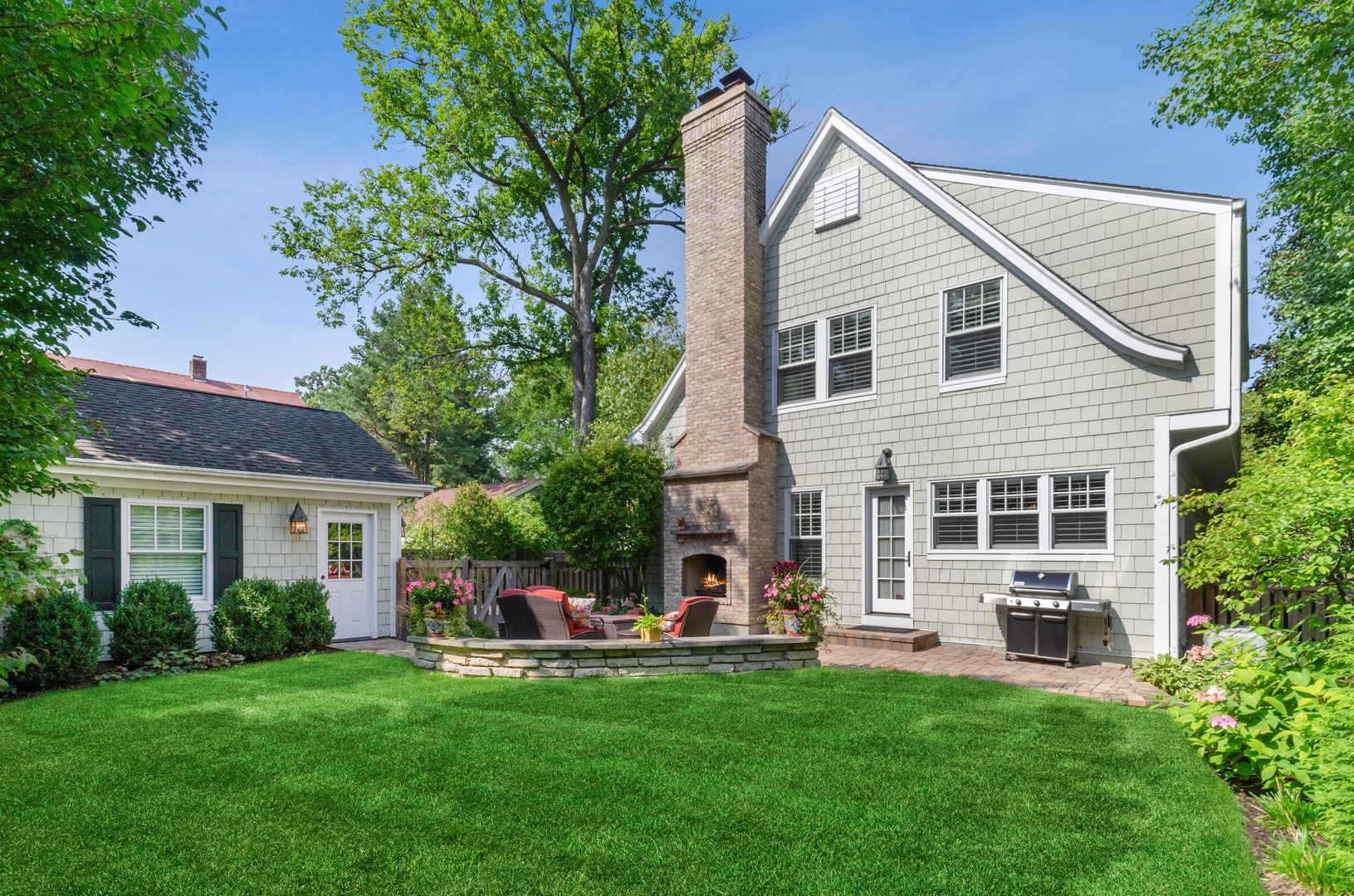 672 Elder Lane Winnetka, IL 60093 - Photo 32 of 32 a front view of a house with a garden and trees