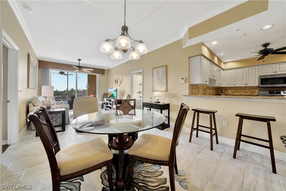 2060 Matecumbe Key Road, Unit 2302 Punta Gorda, FL 33955 - Photo 8 of 30 a view of a dining room with furniture and a chandelier