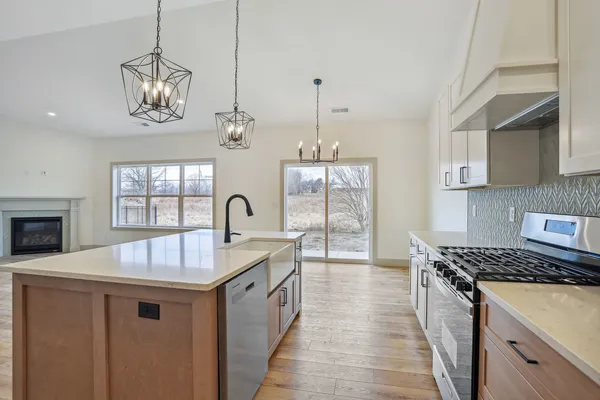 a view of kitchen with kitchen island sink and wooden floor