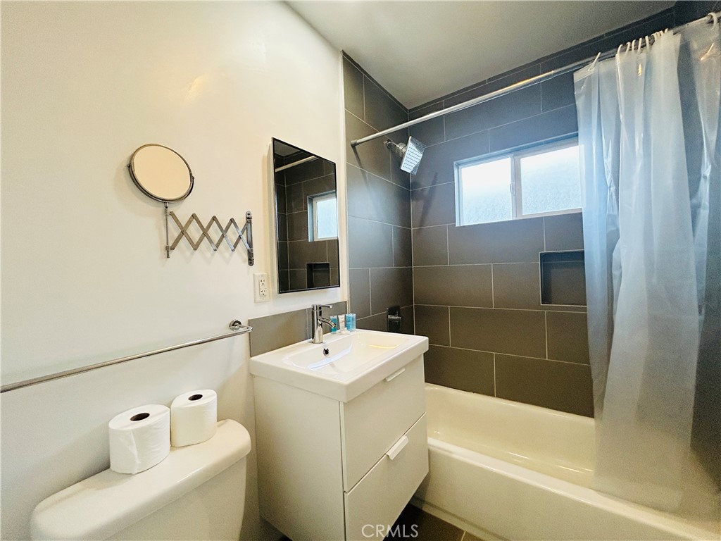 11422 Iowa Avenue, Unit 12 Los Angeles, CA 90025 - Photo 11 of 12 a bathroom with a sink a toilet and shower