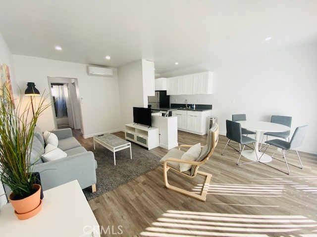 11422 Iowa Avenue, Unit 12 Los Angeles, CA 90025 - Photo 2 of 12 a living room with furniture a rug and white walls