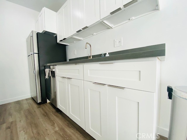 11422 Iowa Avenue, Unit 12 Los Angeles, CA 90025 - Photo 6 of 12 a kitchen with a refrigerator and cabinets
