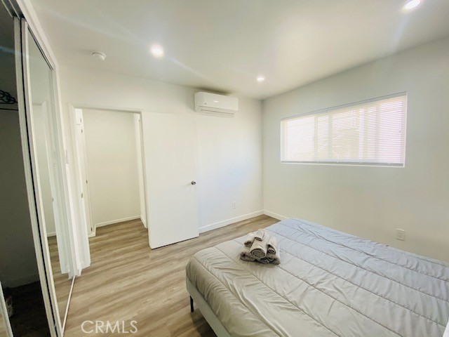 11422 Iowa Avenue, Unit 12 Los Angeles, CA 90025 - Photo 9 of 12 a room with a bed and hardwood floor