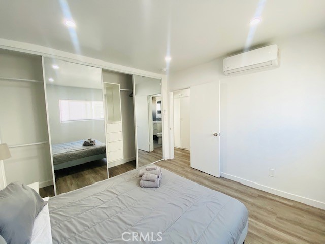 11422 Iowa Avenue, Unit 12 Los Angeles, CA 90025 - Photo 10 of 12 a bedroom with a bed and a large mirror