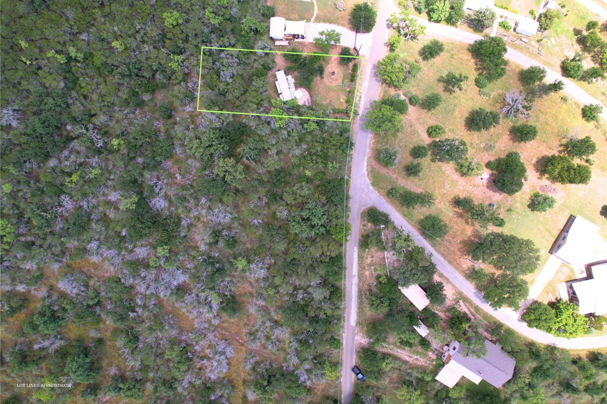 706 Cr138a Road Burnet, TX 78611 - Photo 9 of 18 Aerial view captures a verdant lot amidst mature trees, offering a tranquil natural setting.