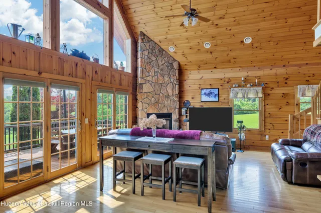 a living room with furniture a flat screen tv and a fireplace