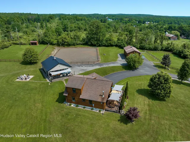 an aerial view of a house with pool big yard and outdoor seating