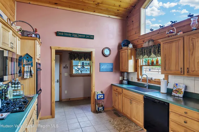 a kitchen with stainless steel appliances granite countertop a sink dishwasher stove and cabinets