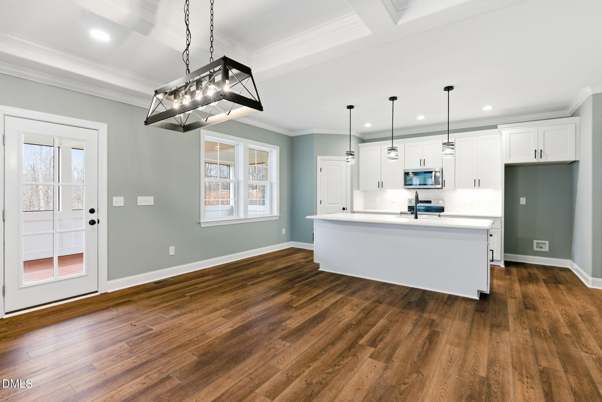 3649 Saxapahaw-Bethlehem Church Road Mebane, NC 27302 - Photo 18 of 69 a kitchen with stainless steel appliances kitchen island a wooden floor and white cabinets