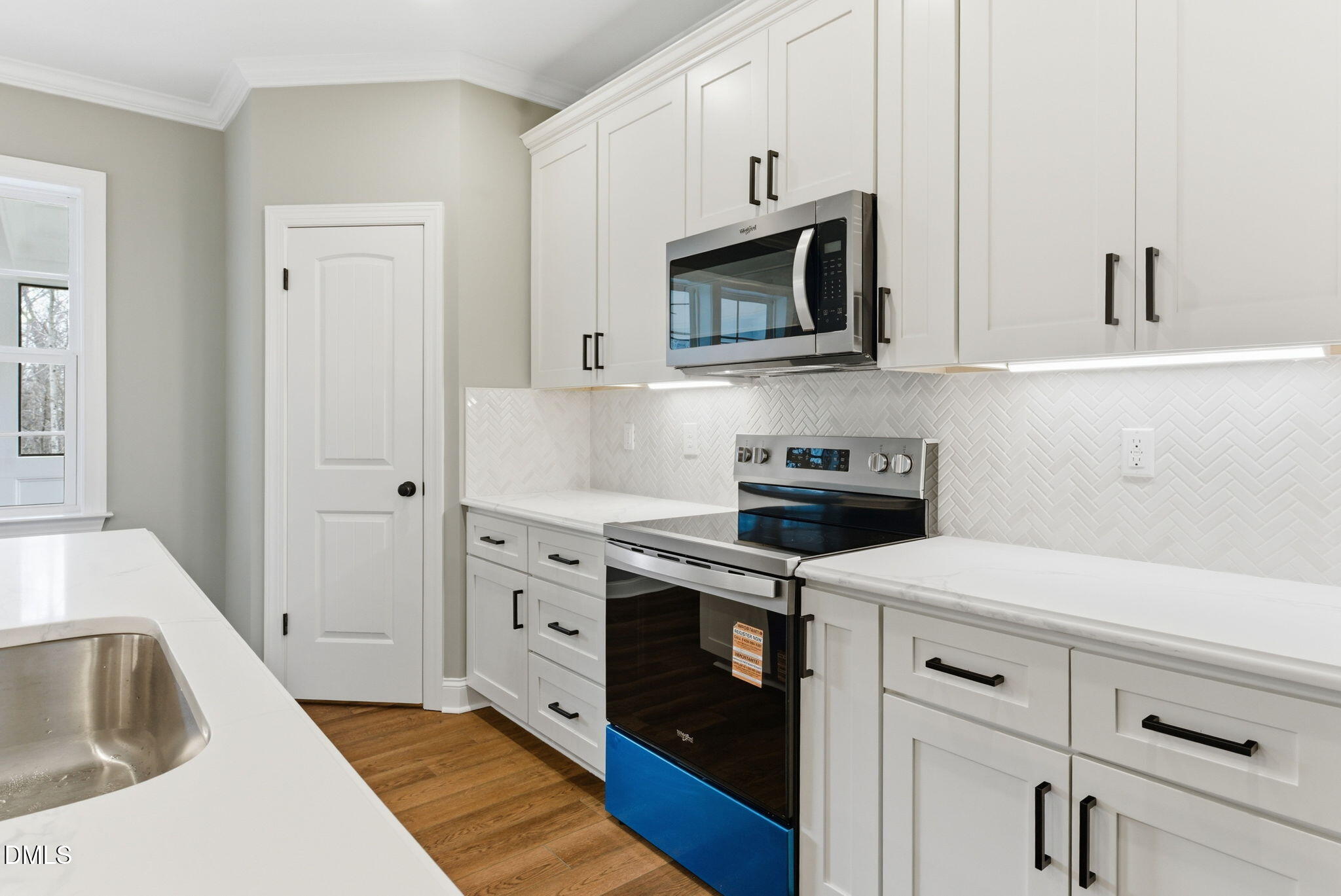 3649 Saxapahaw-Bethlehem Church Road Mebane, NC 27302 - Photo 21 of 69 a kitchen with white cabinets stainless steel appliances and sink