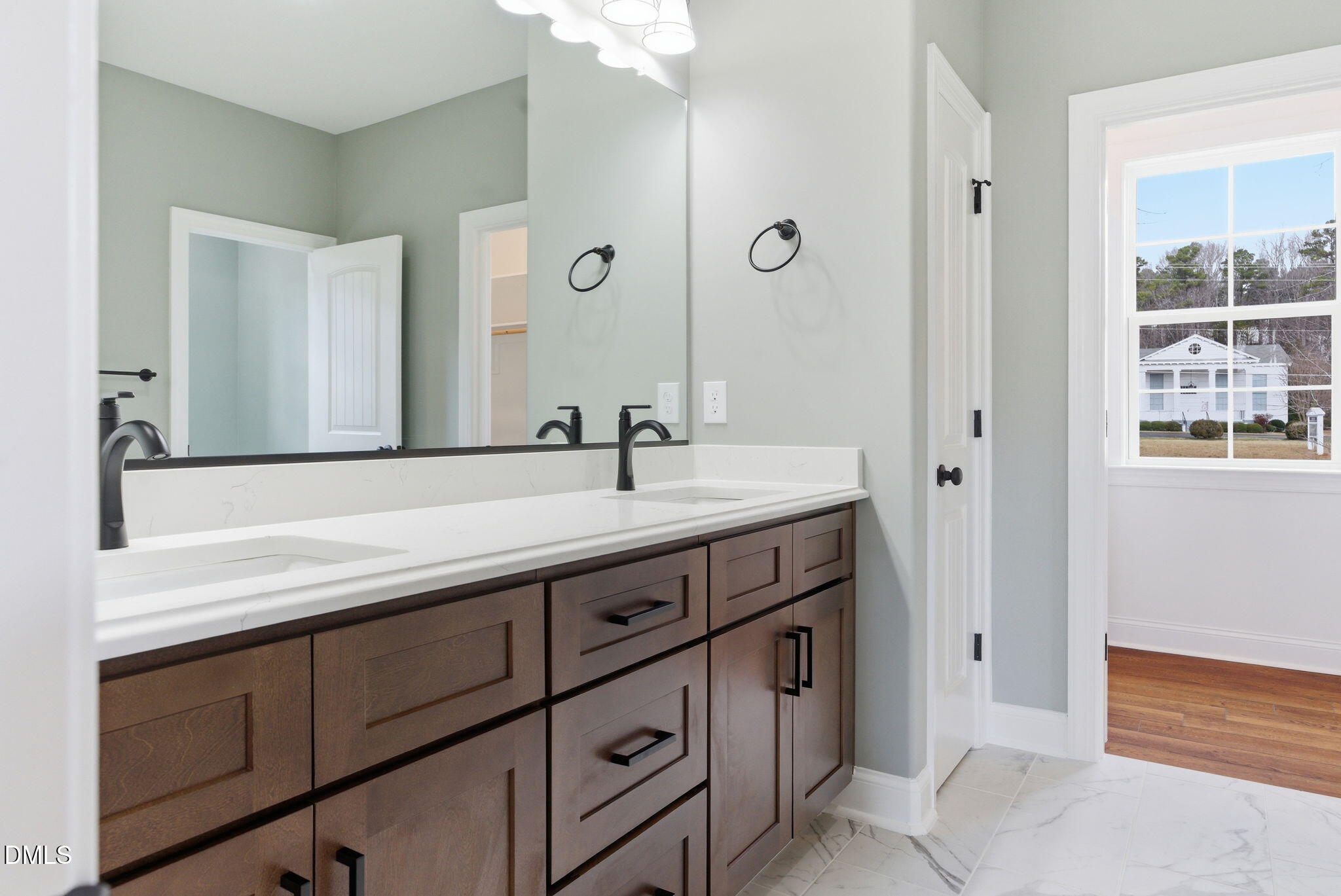 3649 Saxapahaw-Bethlehem Church Road Mebane, NC 27302 - Photo 35 of 69 a bathroom with a double vanity sink and a mirror