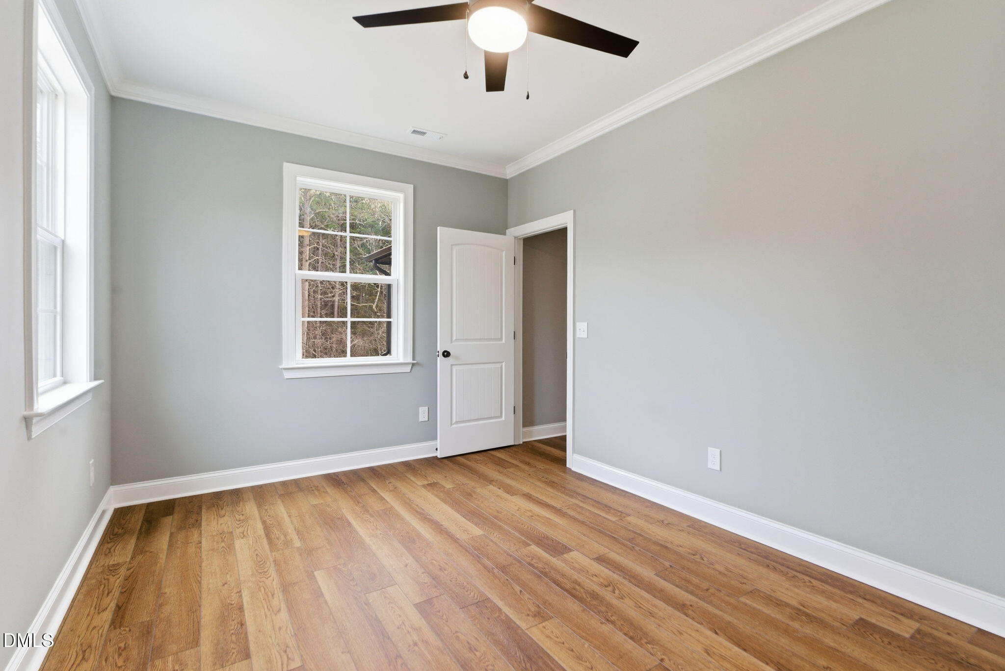 3649 Saxapahaw-Bethlehem Church Road Mebane, NC 27302 - Photo 46 of 69 an empty room with wooden floor chandelier fan and windows
