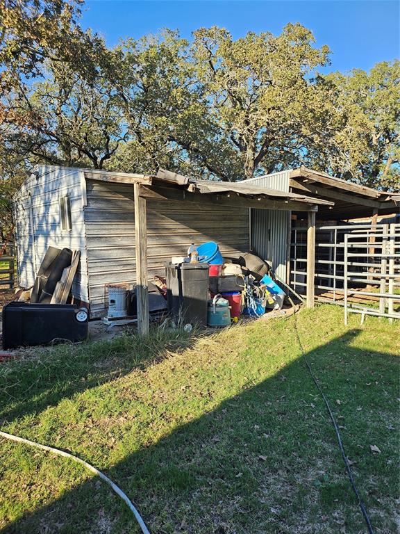 1447 Red Gate Road Mart, TX 76664 - Photo 16 of 19 a view of a house with a backyard space and sitting area