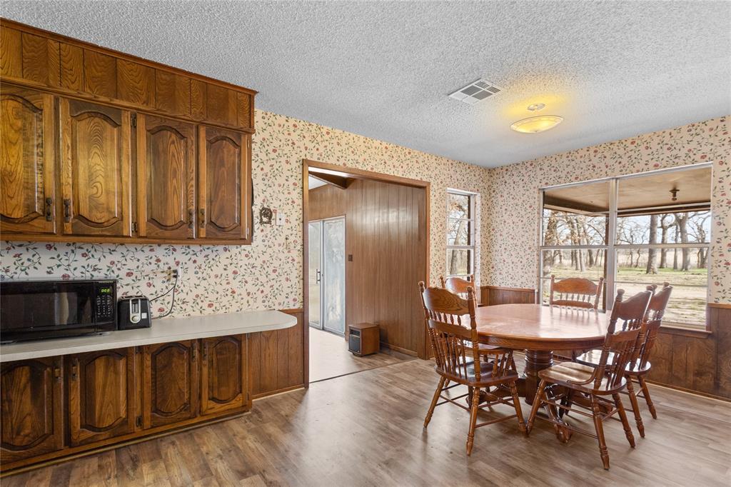 1447 Red Gate Road Mart, TX 76664 - Photo 31 of 38 a view of a dining room with furniture window and wooden floor