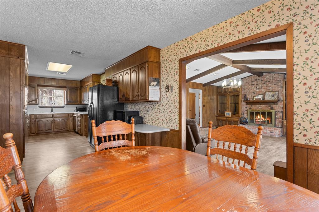 1447 Red Gate Road Mart, TX 76664 - Photo 32 of 38 a large kitchen with stainless steel appliances granite countertop a stove and a refrigerator