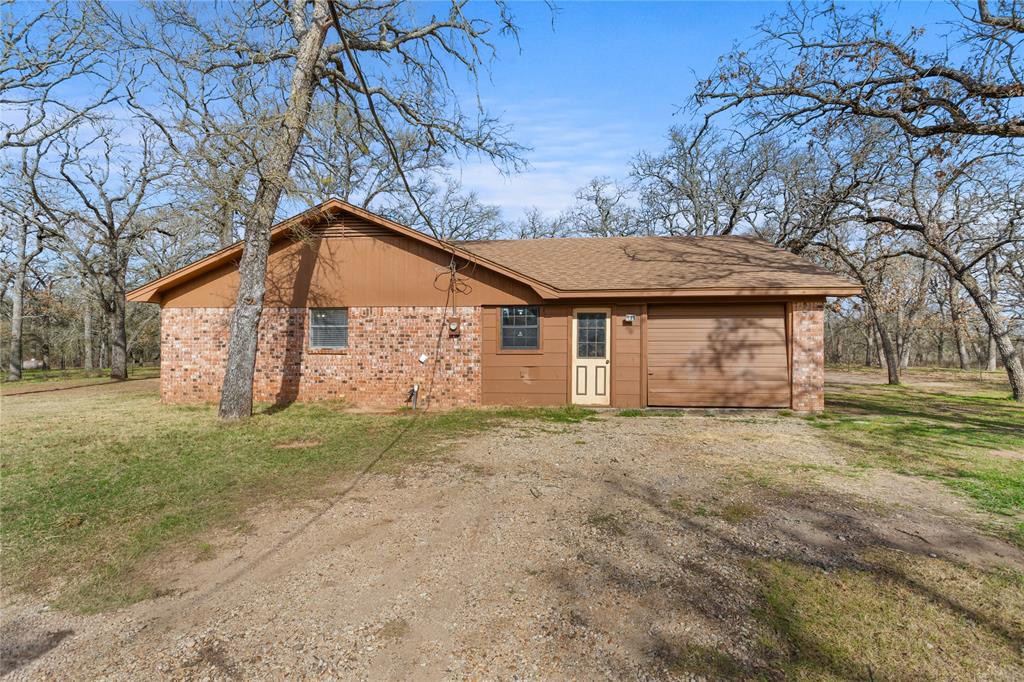 1447 Red Gate Road Mart, TX 76664 - Photo 4 of 38 a view of a house with a yard and large tree