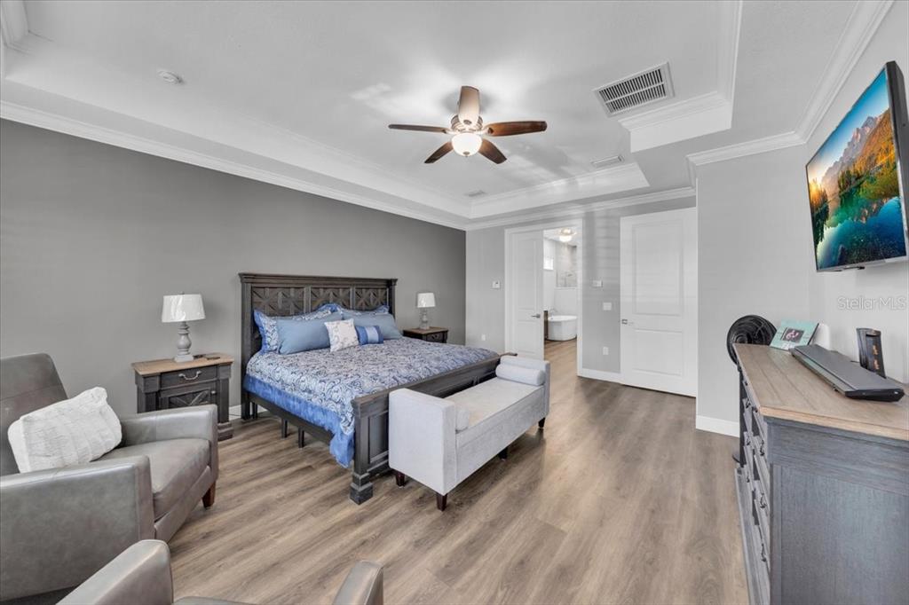 8011 Revels Road Riverview, FL 33569 - Photo 16 of 38 a bedroom with a bed and a flat screen tv