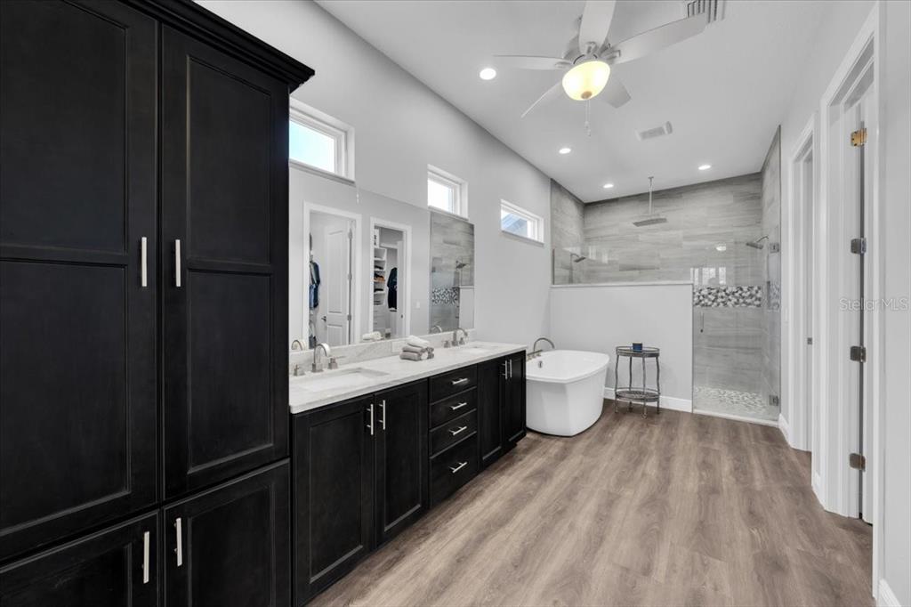 8011 Revels Road Riverview, FL 33569 - Photo 17 of 38 a bathroom with a double vanity sink toilet and a mirror