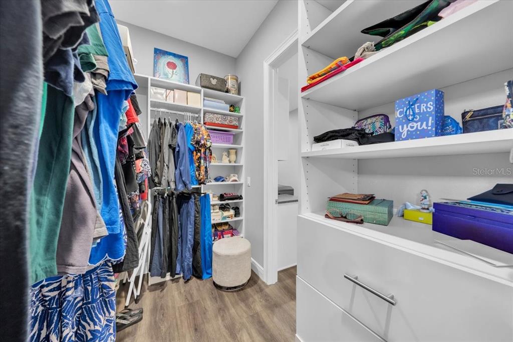 8011 Revels Road Riverview, FL 33569 - Photo 20 of 38 a view of walk in closet with clothes and shoes