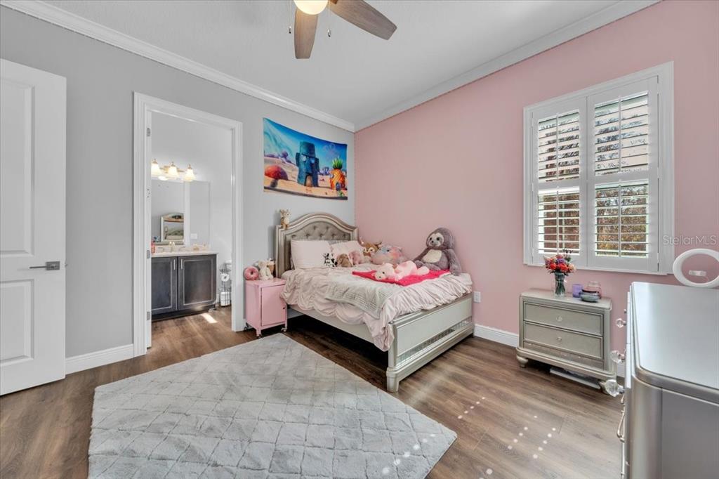 8011 Revels Road Riverview, FL 33569 - Photo 24 of 38 a bedroom with a bed and a chandelier