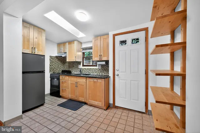 a kitchen with stainless steel appliances granite countertop a refrigerator and a stove