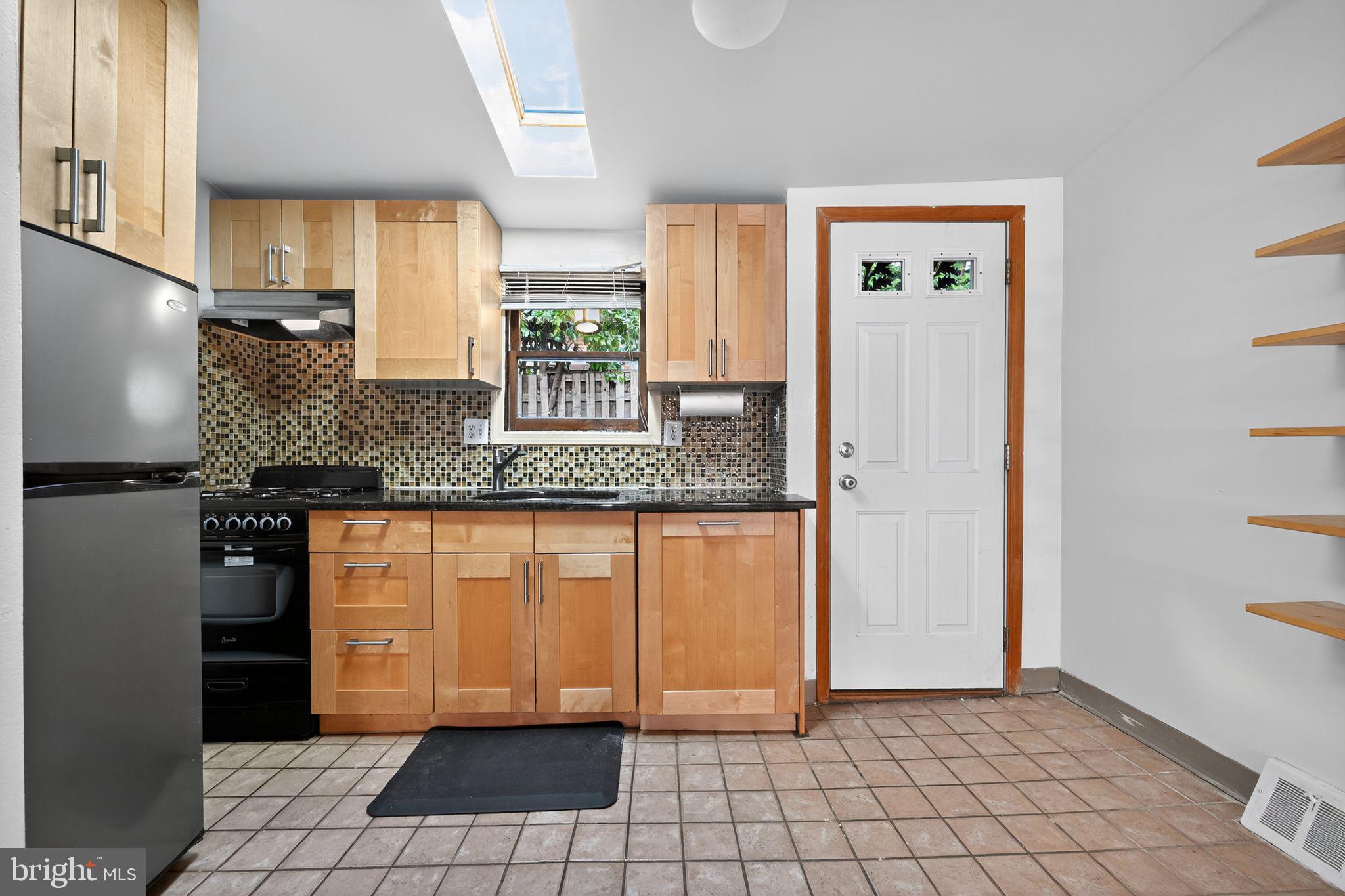 1930 Kater Street Philadelphia, PA 19146 - Photo 12 of 30 a kitchen with granite countertop a refrigerator and a sink
