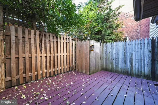 a view of a house with a wooden deck