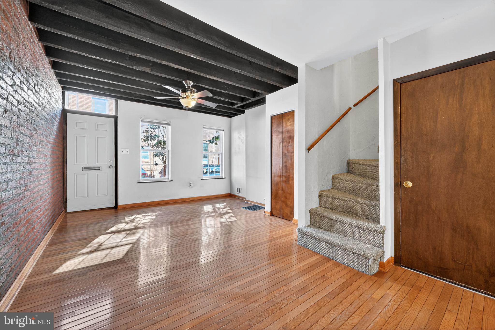 1930 Kater Street Philadelphia, PA 19146 - Photo 5 of 30 a view of an empty room with wooden floor and stairs