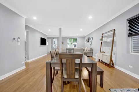 a view of a dining room with furniture and wooden floor