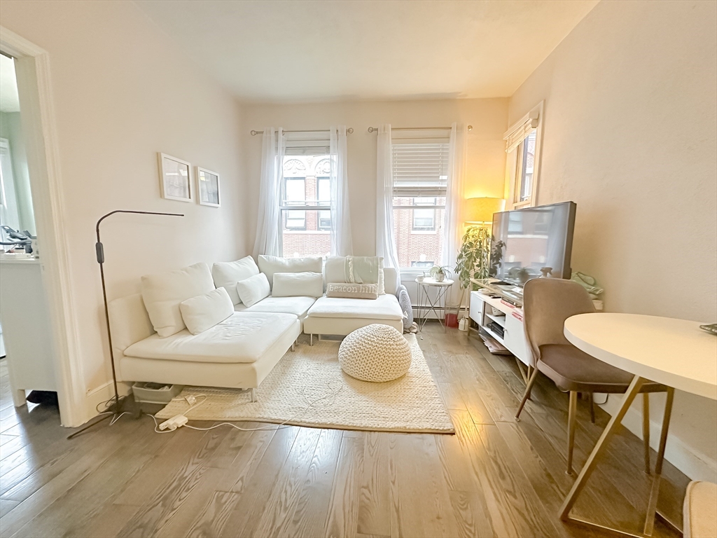 57 Myrtle Street, Unit 3 Boston, MA 02114 - Photo 8 of 10 a living room with furniture and a large window