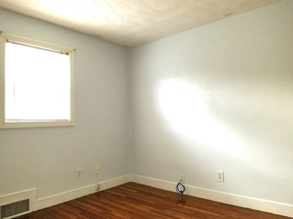 225 Governors Road, Unit 225 Quincy, MA 02169 - Photo 16 of 19 a view of a small space with wooden floor and a window