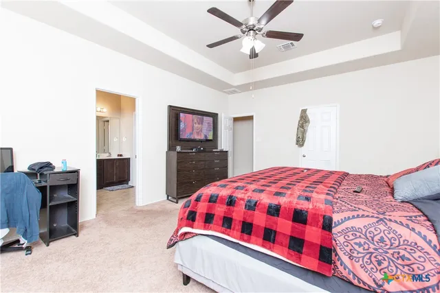 a bedroom with a bed and a chandelier