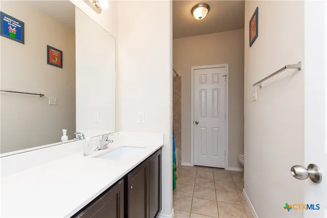 a bathroom with a sink and mirror