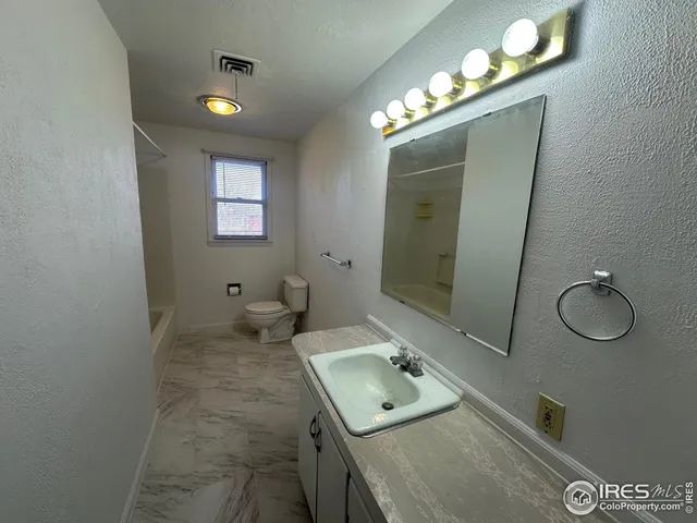 a bathroom with a sink vanity and mirror