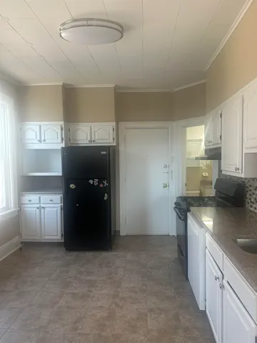 a kitchen with stainless steel appliances granite countertop a refrigerator and a stove
