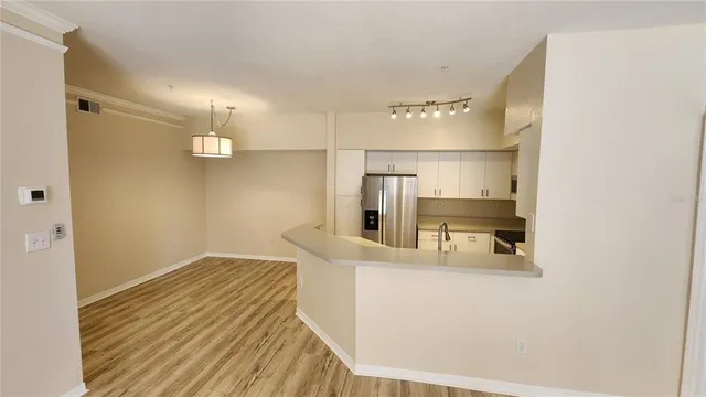 a kitchen with kitchen island stainless steel appliances a sink and refrigerator