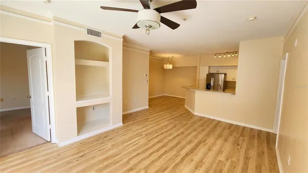 a view of a room with wooden floor