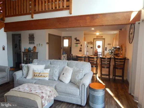 a living room with furniture a mirror and a table