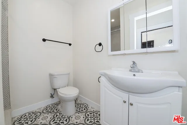 a bathroom with a sink toilet and mirror